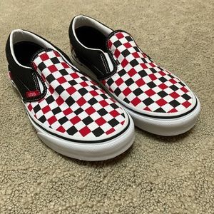Black, red, and white checkered Vans